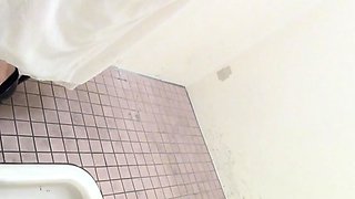 Asian peeing in toilet