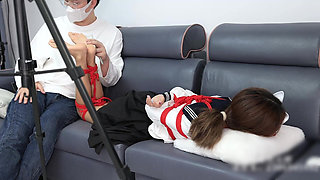 The Barefoot Girl Is Bound with Red Ropes, Tickling Her Feet, and Her Foot Fetishism