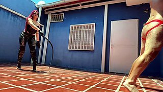 Hot sadistic mistress in leather bullwhips her slave