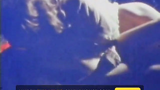 Blue-tinted Vintage Loop Shows Retro Couple in Raw 70s Action