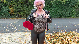 Naughty Granny Tongue Out Flashing Big Tits in Public