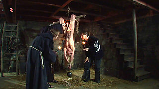 Witch Hangs Upside Down and Gets Drizzled with Black Wax