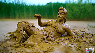 German teen masturbates to orgasm in muddy lake - wet and messy solo fingering