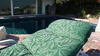 Redhead and blonde MILF having lesbo fun by the pool
