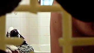 Voyeur spies on a busty mature brunette wife in the shower